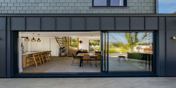 Modern interior of Cornish Secrets holiday home with open-plan lounge and kitchen.