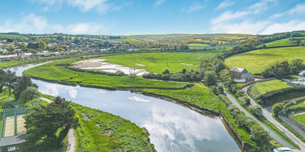 River winding through lush green Cornish countryside.
