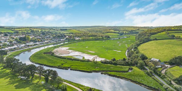 Beautiful river winding through lush green Cornish countryside.