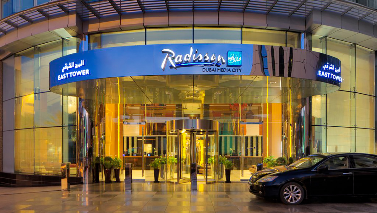 PMI by d2o logo at Radisson Blu Dubai Media City entrance - modern hotel exterior.