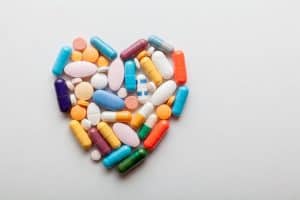 medications in the shape of a heart as heart medications can affect your dental treamtment at our CBD Dental clinic