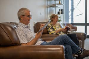 Patient filling out medical history form in the comfortable waiting room of a Brisbane CBD dental clinic