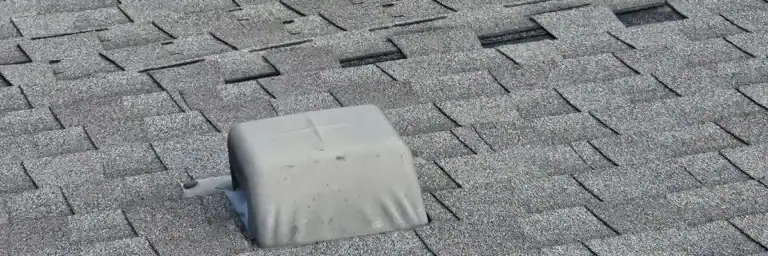 Close-up of cracked and curling roof shingles showing severe roof heat damage San Antonio by Dolan Roofing & Construction