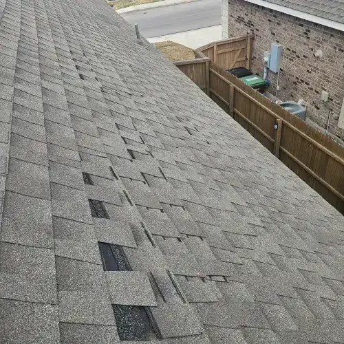 San Antonio roof showing visible heat damage and lifted shingles caused by extreme sun exposure