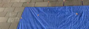 Emergency roof repair using tarp for storm damage by Dolan Roofing & Construction in San Antonio