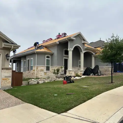 Roofers installing new roofing material on a residential home in San Antonio, representing quality work and flexible roof financing near me