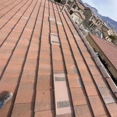 Overhead view of a completed clay tile roof installation with new ventilation upgrades after underlayment replacement by Dolan Roofing & Construction in Texas