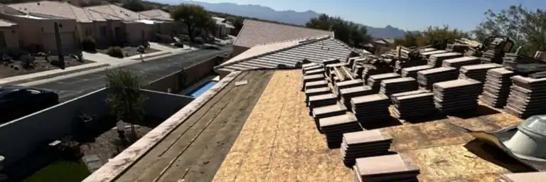 Stacked clay tiles and exposed OSB decking during the lift and relay process for tile roof underlayment replacement in Texas