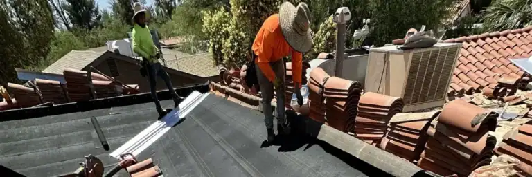 Hailstones on a lawn, indicating potential damage to a tile roof and underlayment by Dolan Roofing & Construction in San Antonio