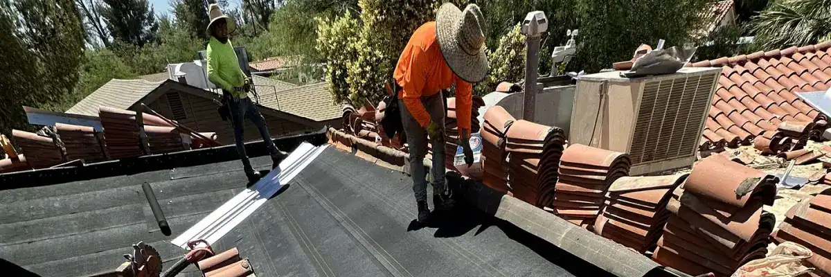 Hailstones on a lawn, indicating potential damage to a tile roof and underlayment by Dolan Roofing & Construction in San Antonio