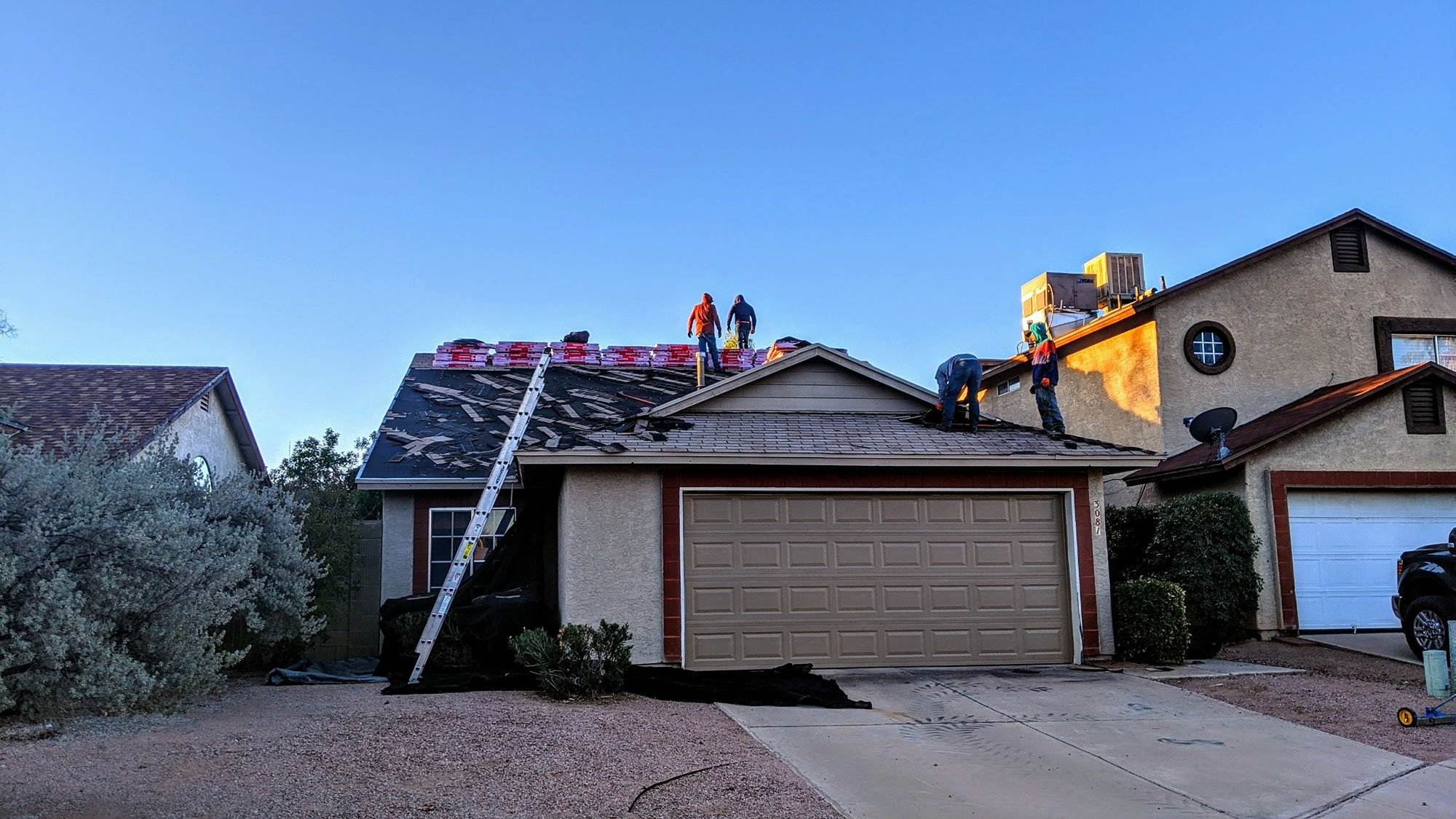 Crew replacing a roof Crew replacing a roof
