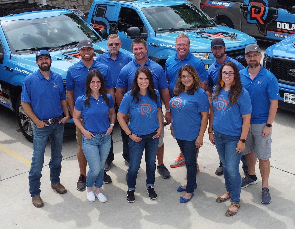 Dolan team photo and trucks