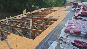 exposed roof framing from crews working to replace damaged roof Dolan Roofing & Construction in San Antonio, TX