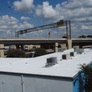 After image of a flat, white roof with several box-shaped HVAC units in San Antonio, TX