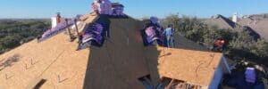 Roofing experts installing asphalt shingles for a durable and weather-resistant roof.