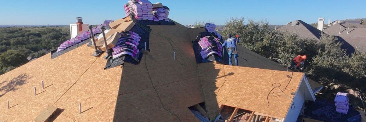 Roofing experts installing asphalt shingles for a durable and weather-resistant roof.