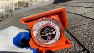 roof pitch tool on top of a roof by Dolan Roofing & Construction in San Antonio,TX