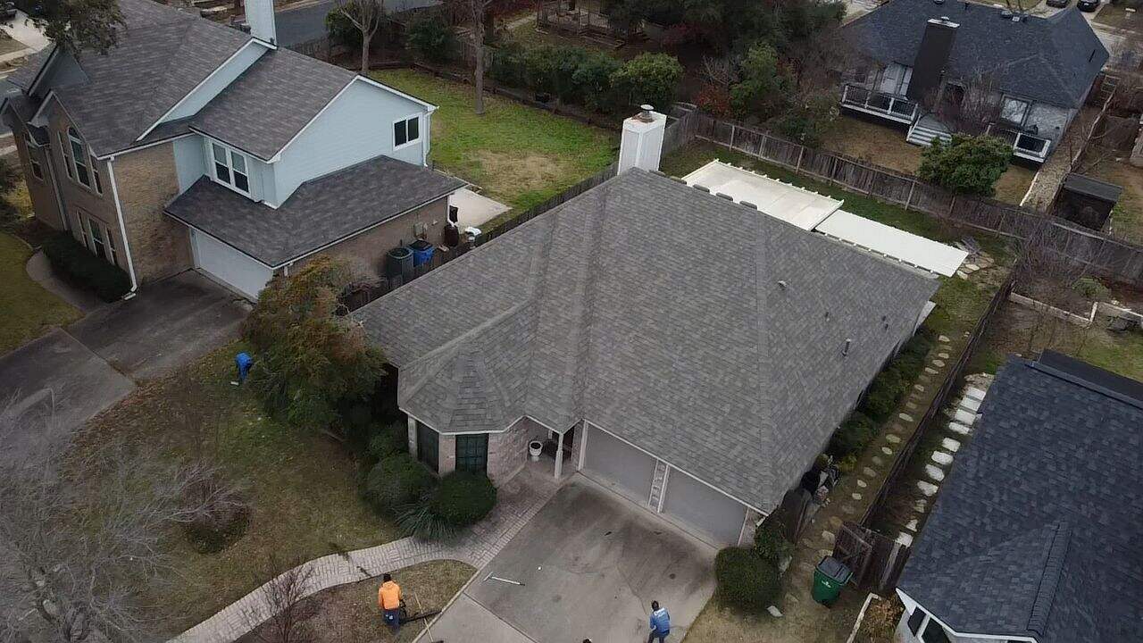 Full property aerial showing Owens Corning Oakridge Driftwood shingle roof and landscaping by Dolan Roofing & Construction in Oakridge