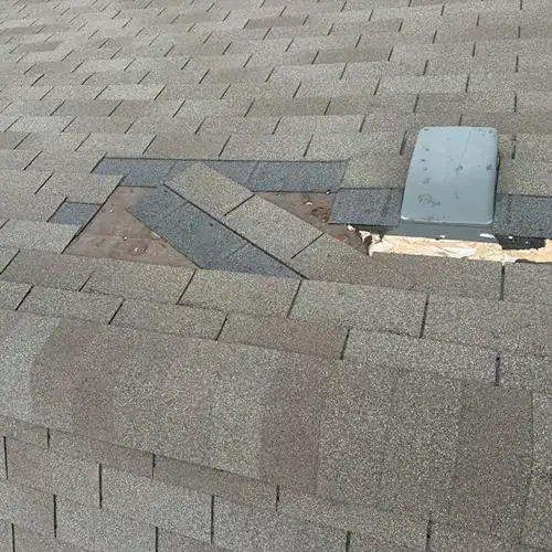 Shingles showing granule loss as evidence of wind damage by Dolan Roofing & Construction