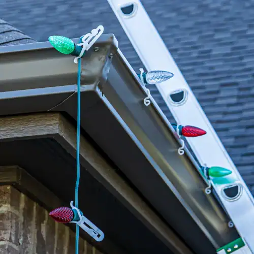 Close-up of plastic light clips securing Christmas