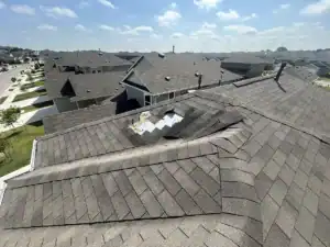 Missing and damaged shingles exposing underlayment as clear signs of roof wind damage by Dolan Roofing & Construction