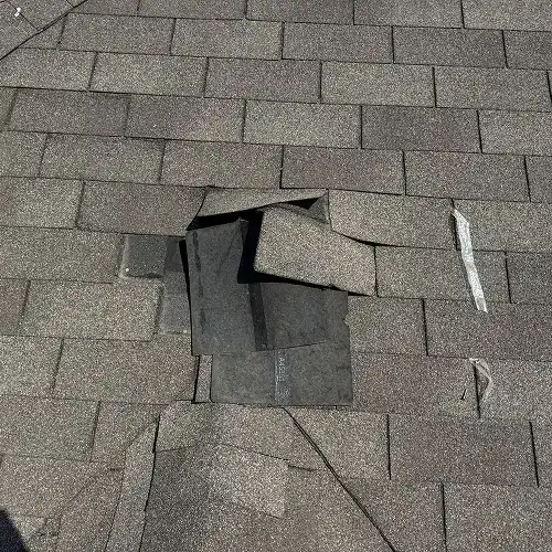 Moisture stains on interior ceiling from roof wind damage by Dolan Roofing & Construction