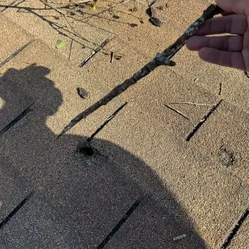 Inspecting roof damage with a stick—understanding actual cash value vs replacement cost roof insurance in San Antonio