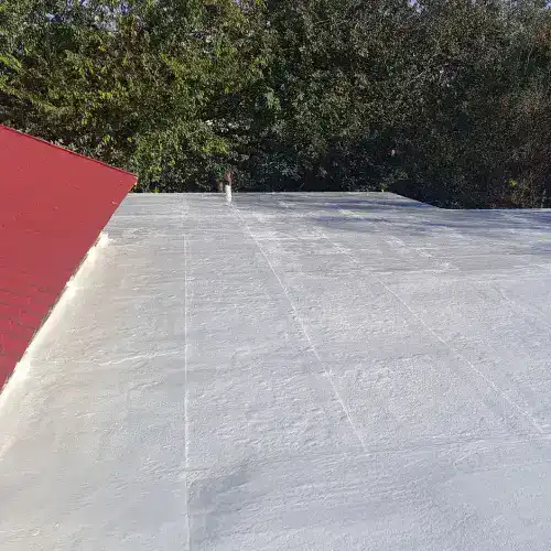 Flat commercial roof with waterproof coating in San Antonio, protected by Dolan Roofing & Construction
