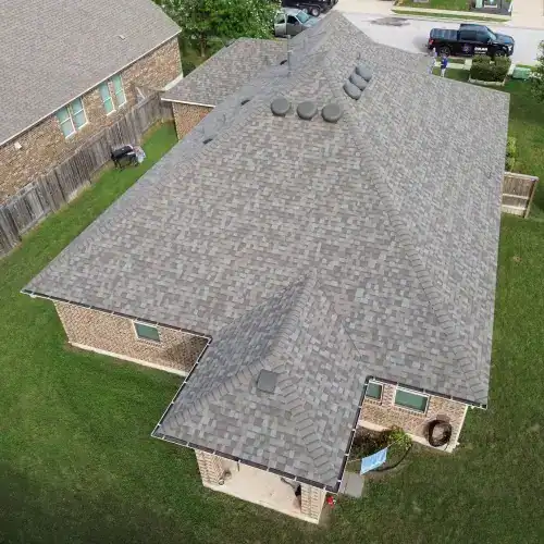 A residential building with a beautifully finished tile roof, representing an investment that may be a roof replacement tax deductible by Dolan Roofing & Construction in San Antonio