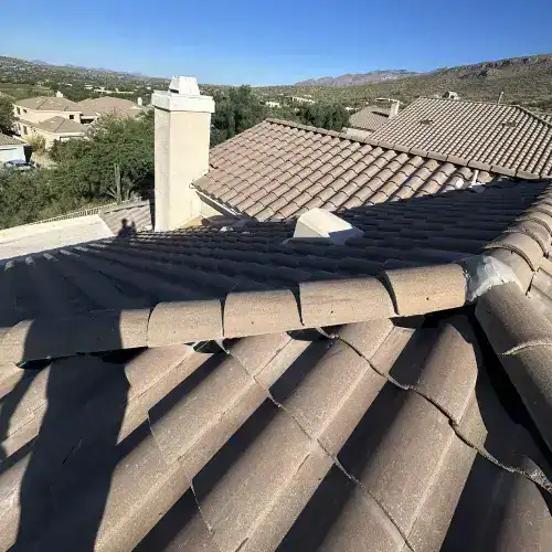 A finished tile roof and chimney on a residential home, showcasing a quality tile roof underlayment project by Dolan Roofing & Construction in San Antonio