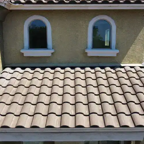 A finished tile roof on a residential building, showcasing quality installation and underlayment by Dolan Roofing & Construction in San Antonio