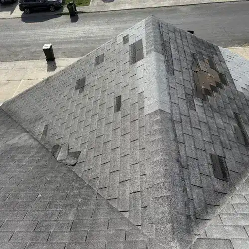 A residential roof with missing and damaged shingles, key roof leak warning signs by Dolan Roofing & Construction in San Antonio