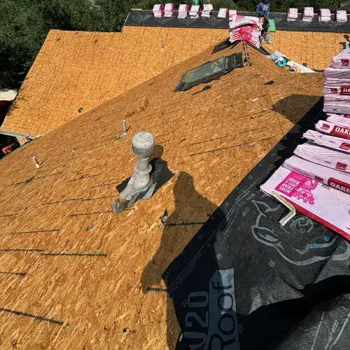 A residential roof with new plywood decking and underlayment installed, a crucial step after obtaining roofing permits in San Antonio.