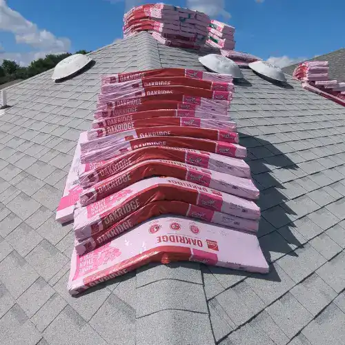 A hand holding a calculator with receipts, symbolizing the financial aspects of a roof replacement and the potential for tax benefits by Dolan Roofing & Construction in San Antonio