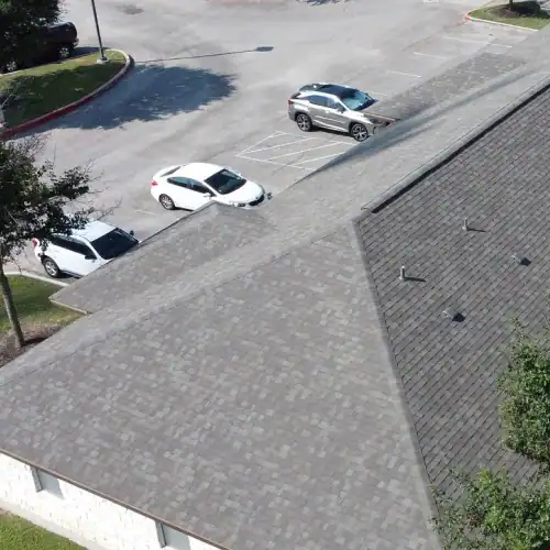 Cedar Park roof replacement featuring newly installed asphalt shingle roofing on a commercial building by Dolan Roofing & Construction in San Antonio