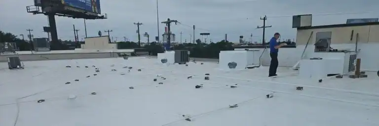 Technicians conduct commercial roof maintenance inspection on a flat white roof in San Antonio, TX, as part of Dolan Roofing & Construction’s commercial roof maintenance program
