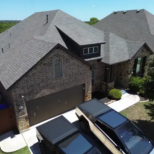 Brick home in San Antonio with newly installed asphalt shingle roof viewed from above, showcasing roof replacement San Antonio by Dolan Roofing & Construction