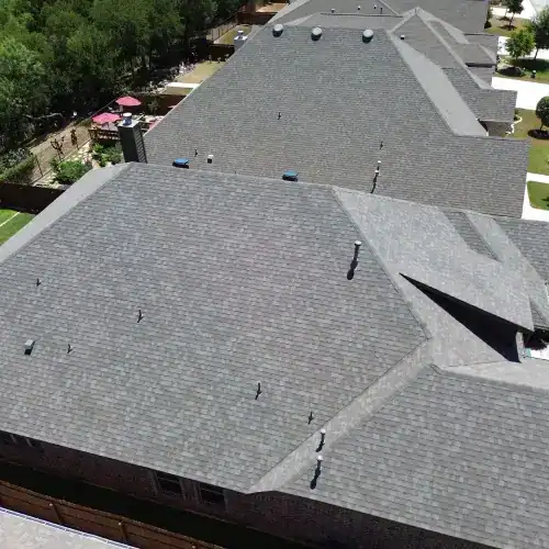 Aerial view of newly replaced residential roofs in San Antonio, featuring fresh shingles and quality roofing work by Dolan Roofing & Construction