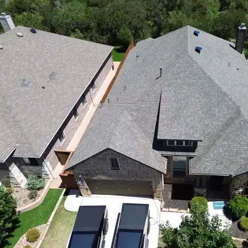 Aerial view of a San Antonio home with a newly completed asphalt shingle roof, representing roof replacement San Antonio by Dolan Roofing & Construction