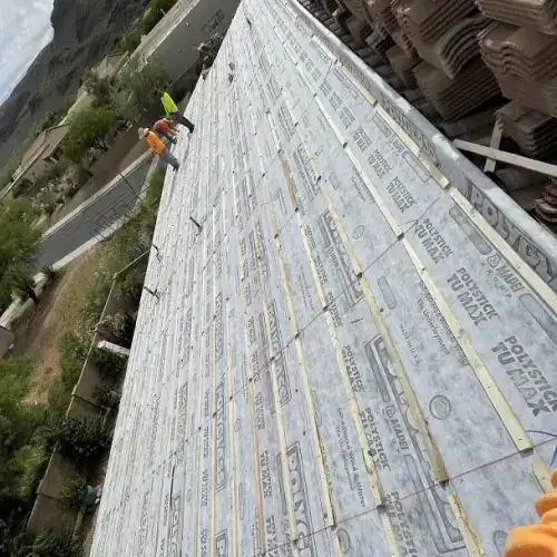 Tile roof lift and relay cost San Antonio with new underlayment installation and stacked tiles by Dolan Roofing & Construction in San Antonio