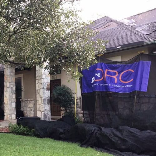 Dolan Roofing & Construction project banner displayed during roof installation at Timberwood Park home