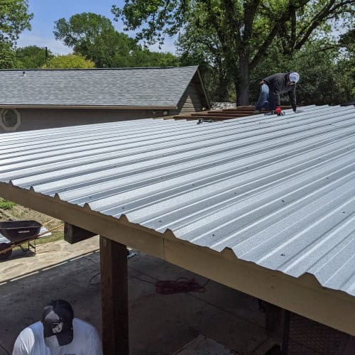 Metal carport roof installation as part of residential roofing project by Dolan Roofing & Construction in Alamo Heights