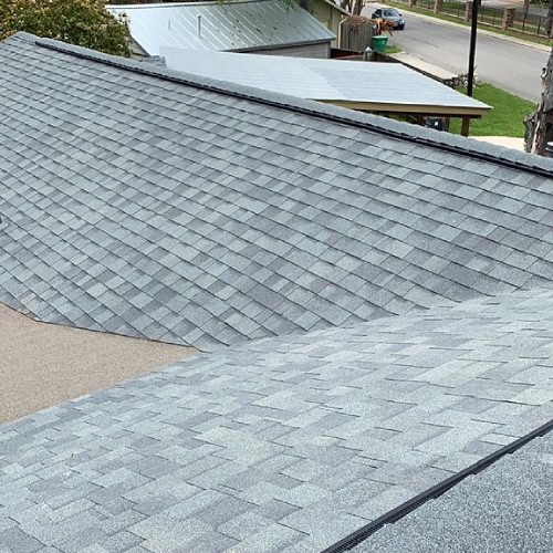 Multi-slope roof with architectural shingles for residential home by Dolan Roofing & Construction in Alamo Heights
