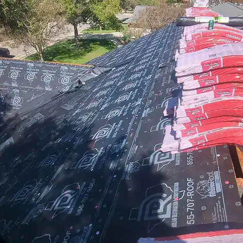 Roofing underlayment and shingles prepared for roof repair by Dolan Roofing in Seguin, TX
