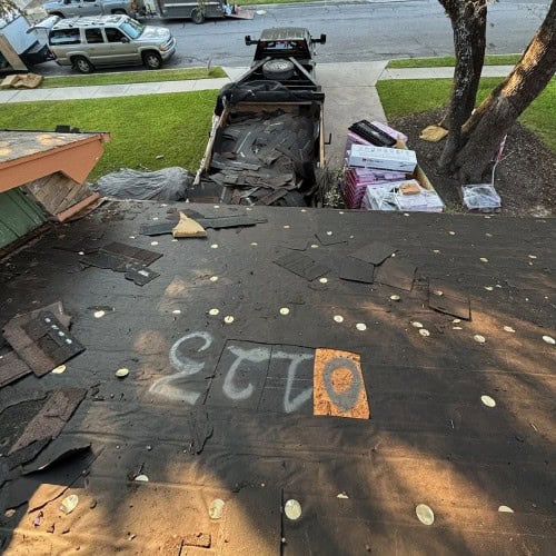 Roof teardown and shingle removal underway at 8511 Odyssey Drive by Dolan Roofing & Construction in Universal City