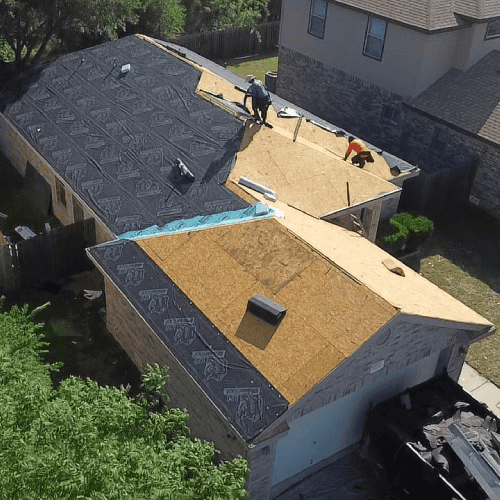 Roofing contractors installing new decking and underlayment at 9931 Amberg Path by Dolan Roofing & Construction in Helotes