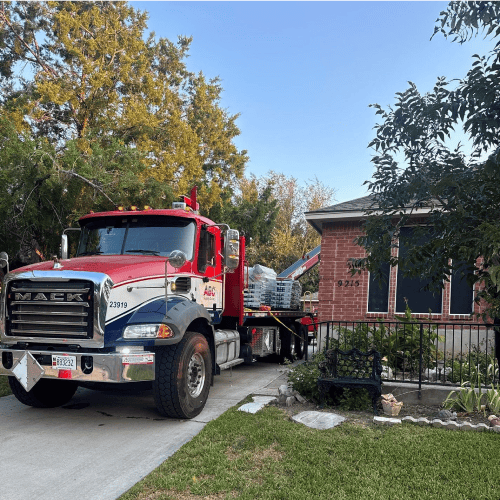 Mack truck delivering roofing supplies for Helotes roof replacement by Dolan Roofing & Construction in Helotes