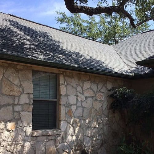 Freshly installed Owens Corning Oakridge shingles complementing stone façade by Dolan Roofing & Construction in Timberwood Park