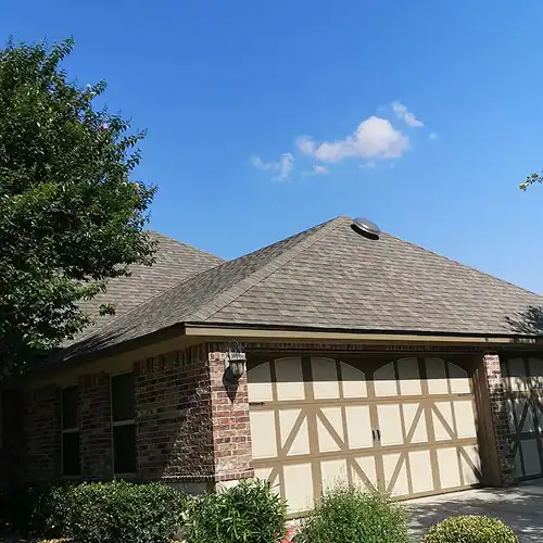 Well-maintained asphalt shingle roof on brick home showcasing professional roof maintenance in New Braunfels by Dolan Roofing & Construction in Cibolo