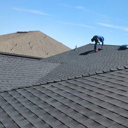 Roofer installing GAF Timberline Natural Shadow shingles on a new roof by Dolan Roofing & Construction in Cibolo